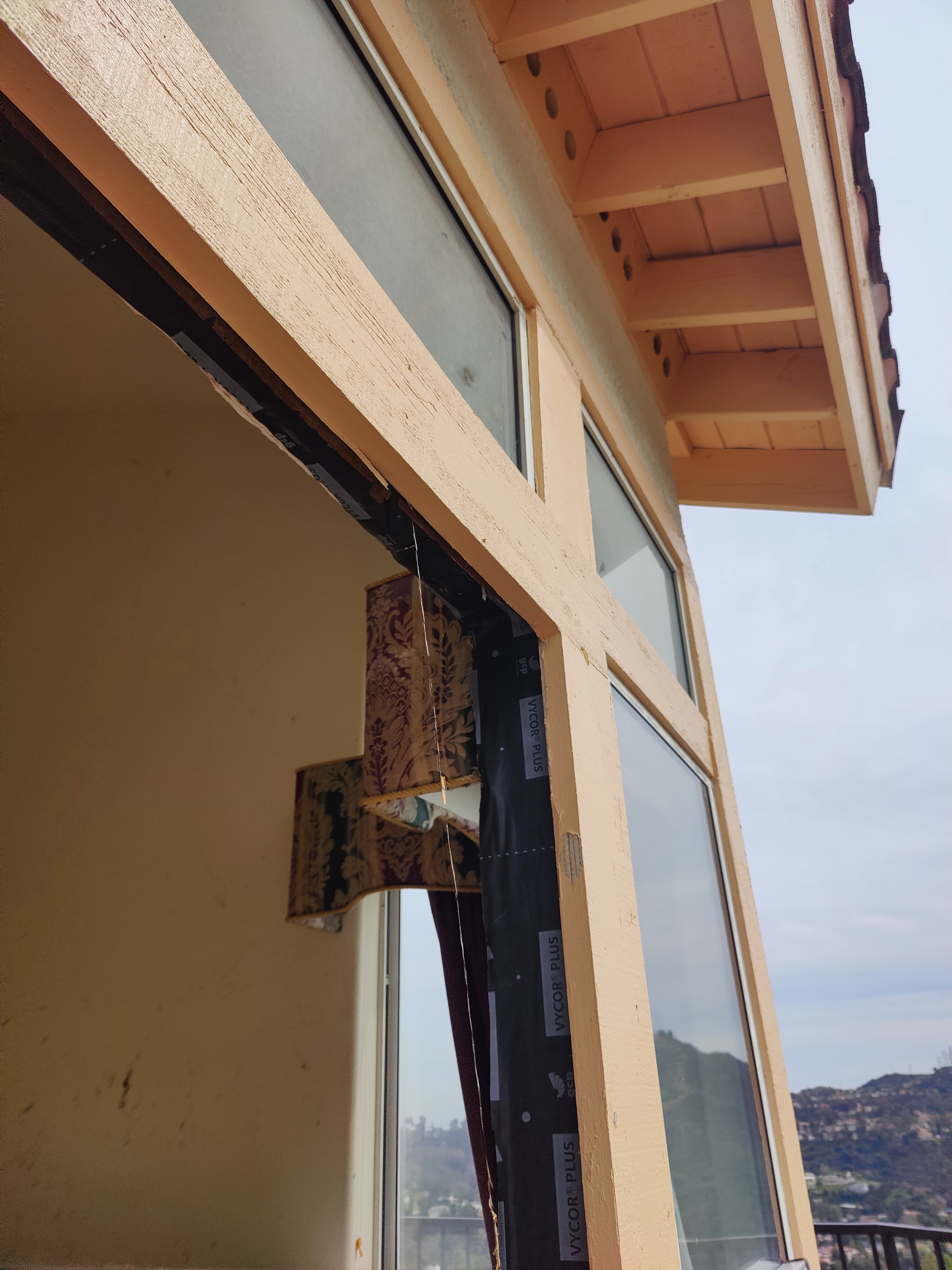 Exterior door trim with flashing membrane applied for weatherproofing