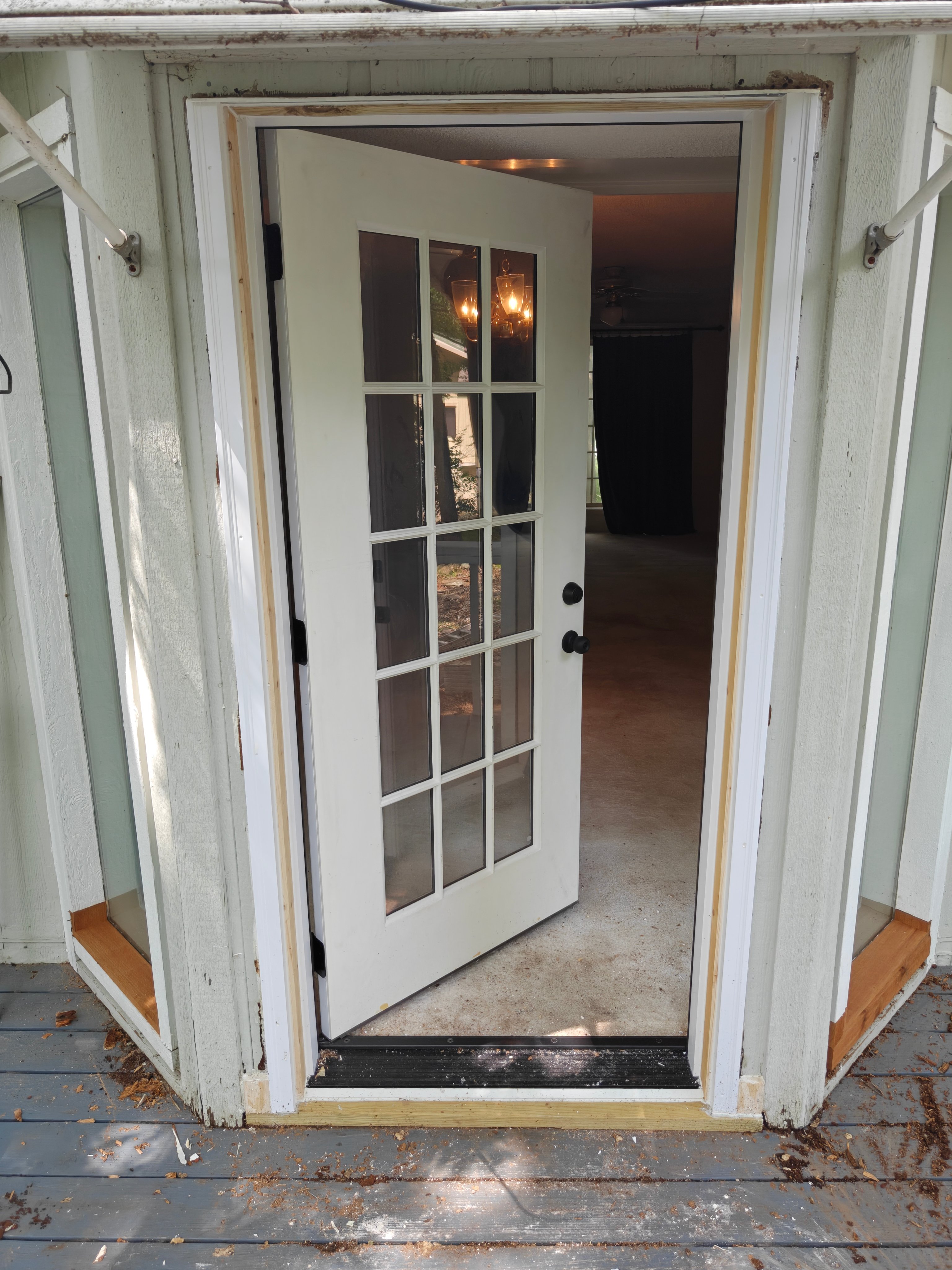 New French door installed and open showing interior and new threshold in Bella Vista