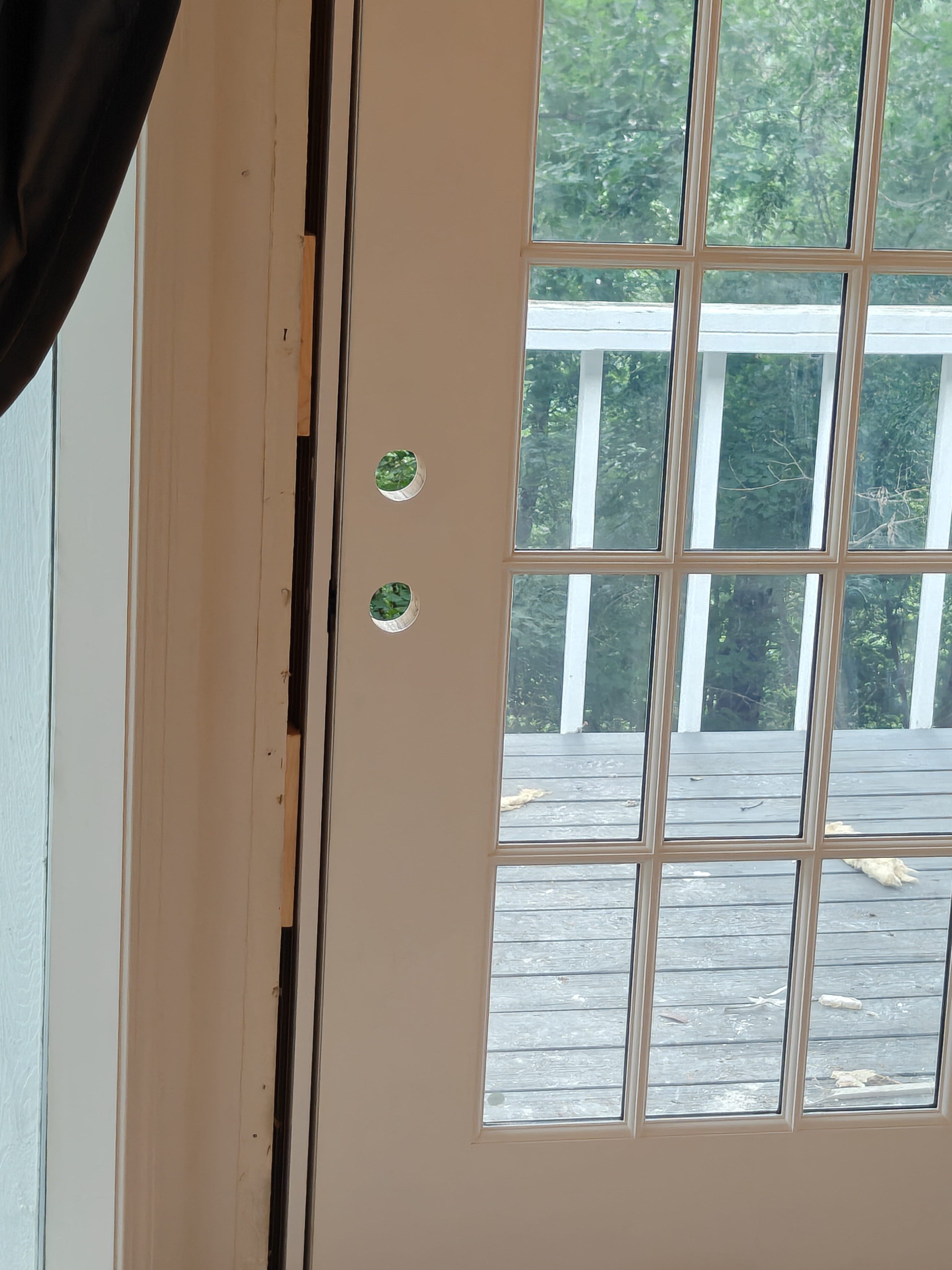 New French door with lockset and deadbolt holes bored during preparation in Bella Vista