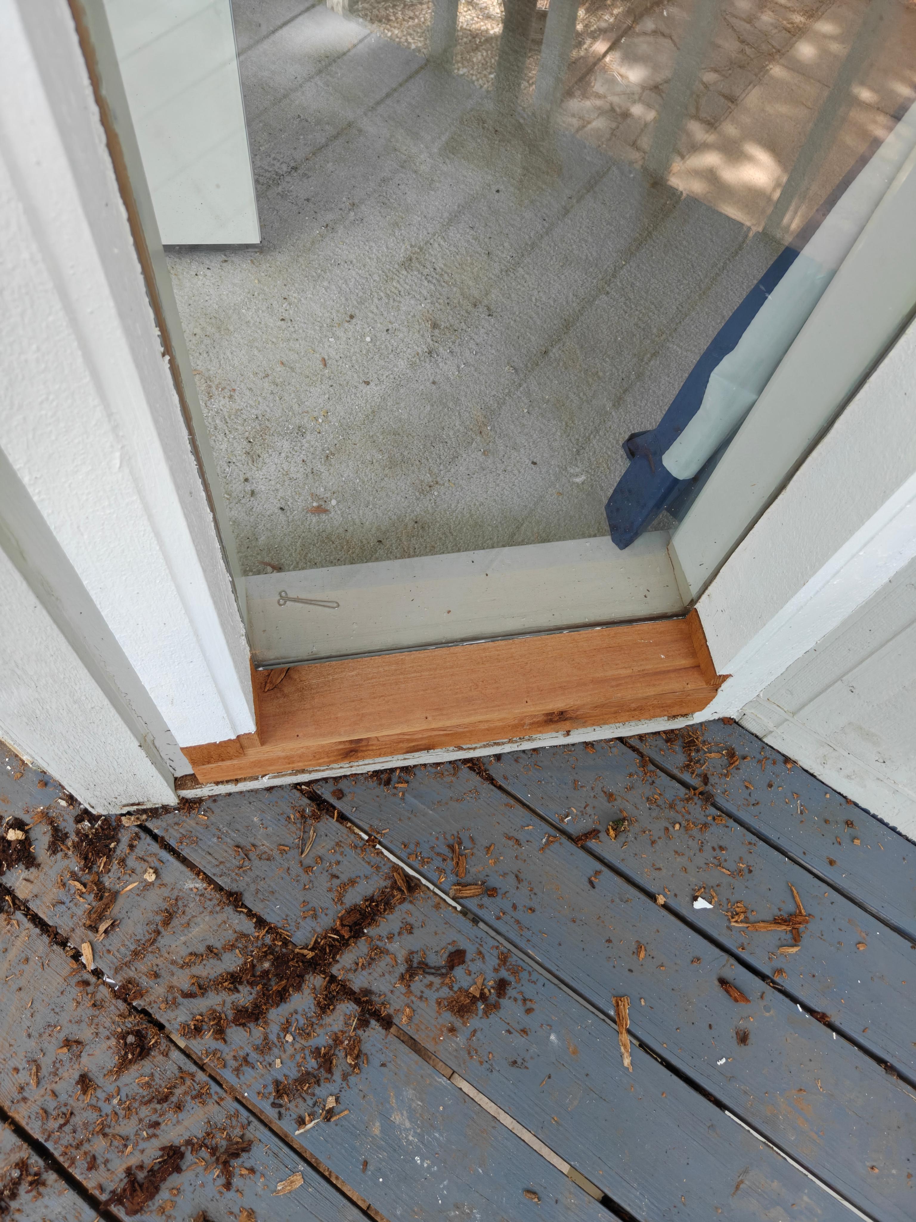 New solid oak door threshold installed and sealed during door replacement in Bella Vista