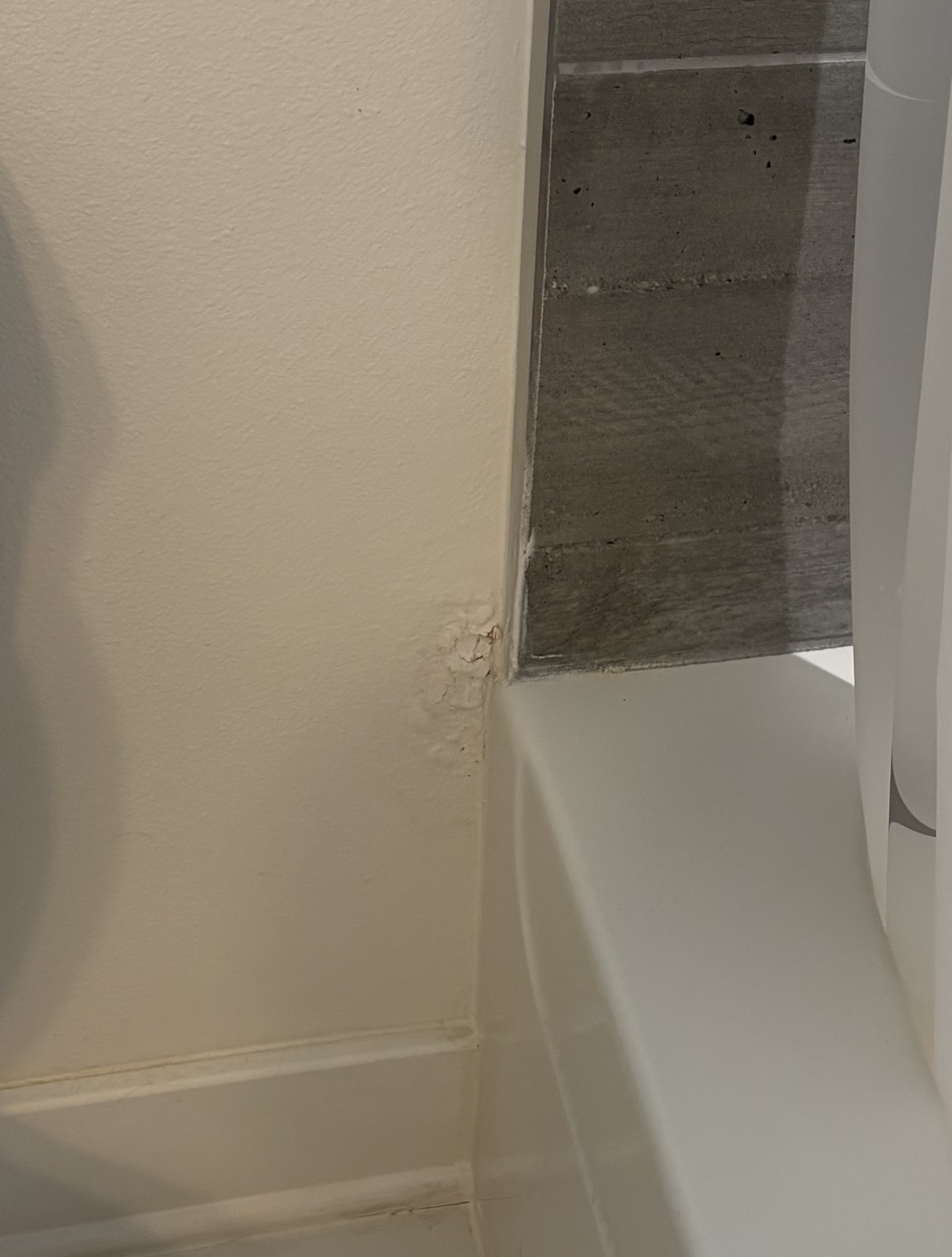 Cracked and damaged drywall at wall corner before patching in Fayetteville