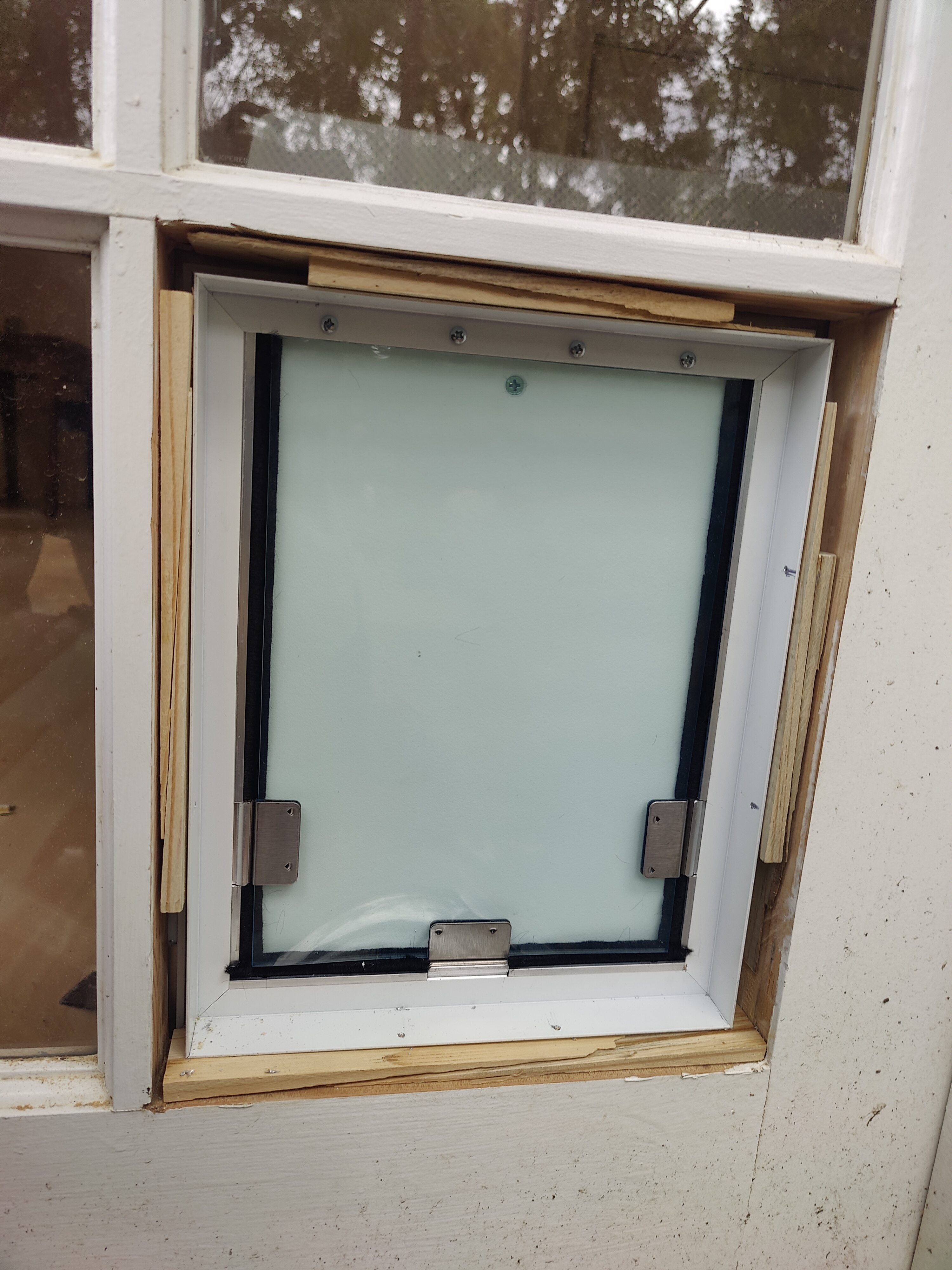 Pet door flap mounted in French door - installation in progress